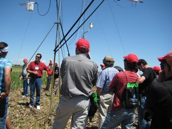 University of Nebraska's Suat Irmak, facing camera, explains how a high-technology weather station in Nebraska continuously monitors crop evapotraspiration and crop coefficients during the growing season. Irmak presents the keynote address to California farmers Sept. 12.