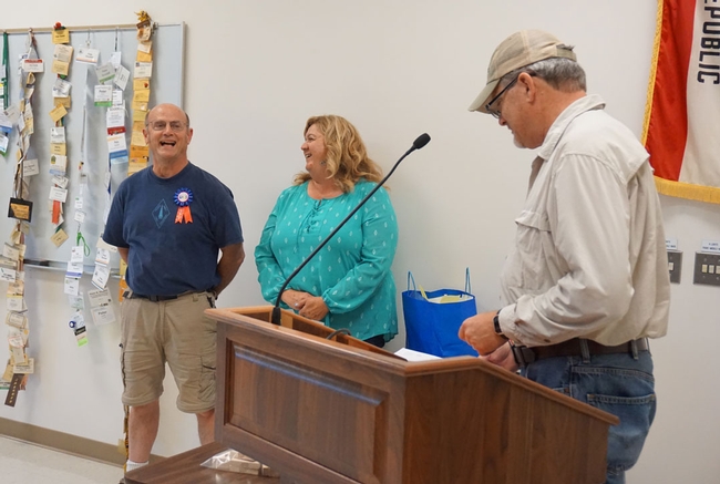 Kearney director Jeff Dahlberg, right, presented letters, a certificate and medallion to the retiring advisor. In the center is Pete's longtime colleague Cherie McDougald.