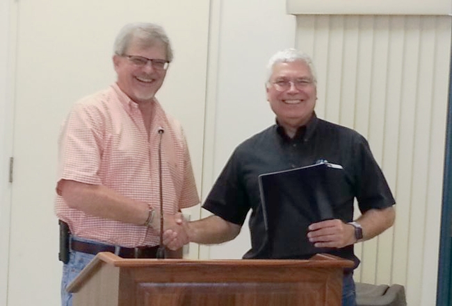 They are all smiles as Director Jeff Dahlberg congratulates David Grantz on his retirement after 29 years.