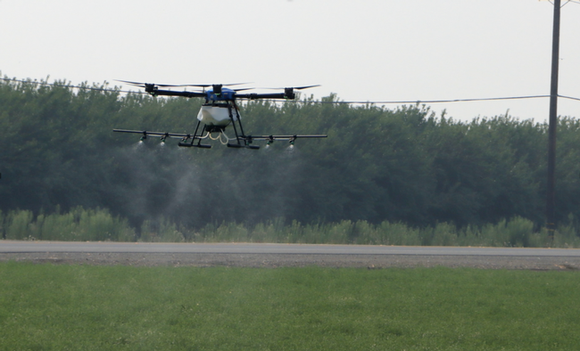 Photo 1. Drone appication of pesticides for summer worm control in alfalfa hay.