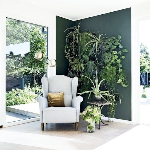 Indoor Zen Corner with white upholstered chair, small table, and plants.