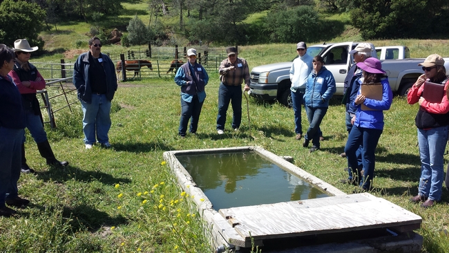 Joe Spencer explaining his wildlife friendly water trough design to workshop participants.