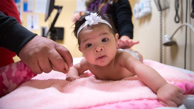 Four-month-old receives a well-baby check at the CommuniCare Salud Clinic in West Sacramento, Calif.  Photo-Carl CostasPolitico