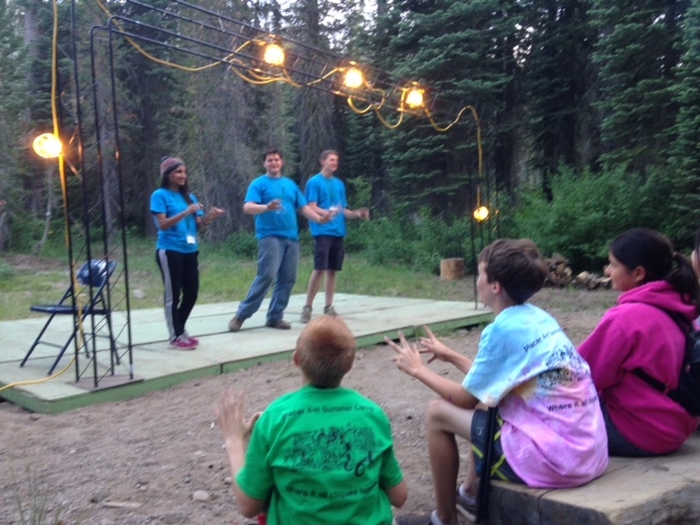Junior Camp Directors Speaking With Campers At Nightly Camp Fire