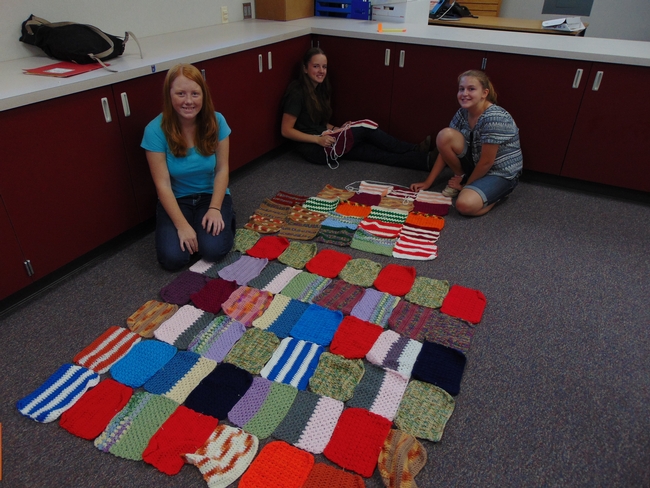 4-H girls work on putting together their blankets for Warm up America