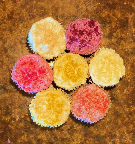 Fruit powder added to frosting on cupcakes.