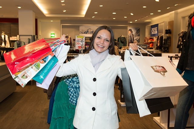 Woman holding 8 shopping bags with merchandise
