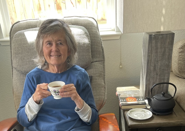 Author with a cup of tea and a good book.