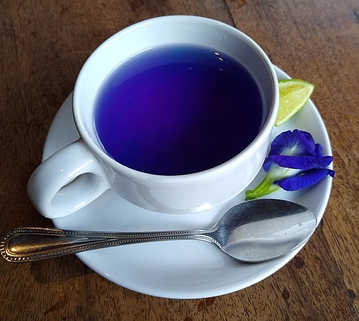 Teacup holding a bright blue beverage.