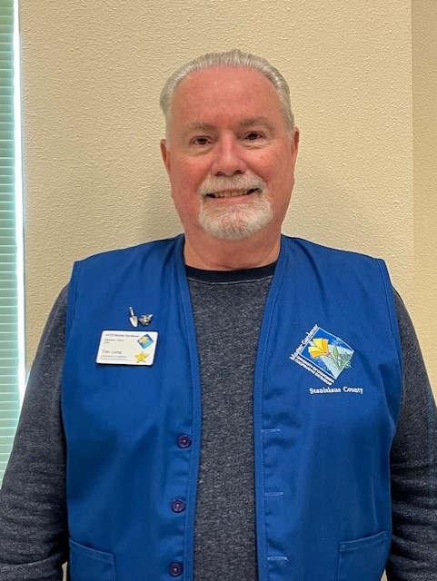 Picture of man wearing blue vest and smiling.