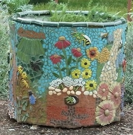 Mosaic on concrete planter that depicts coneflower and black-eyed Susan plants
