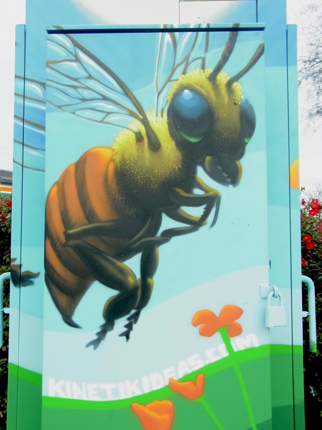 Closeup view of the bee on the painted utility box