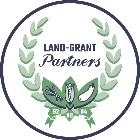 Logo of the Land Grant Summit in a circle formation with green and white lettering around an olive branch