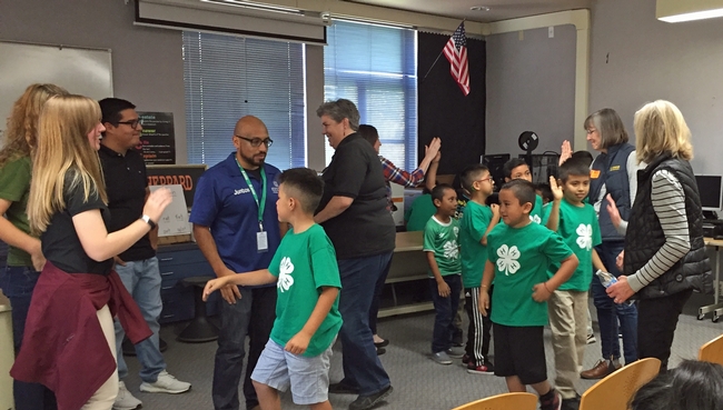 After telling Regent Stegura, VP Humiston and others what they like about 4-H, the 4-H members exchanged high-fives with the group.