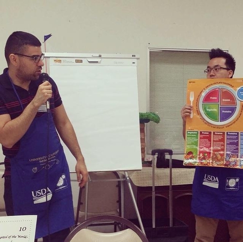Nutrition Educators, Javier Miramontes and Tacu Vang reviewing Myplate with Participants at the Selma Senior Center.