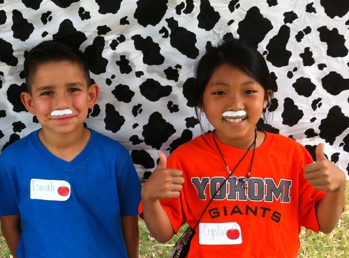 Students Isaiah and Crystal model their milk mustaches.
