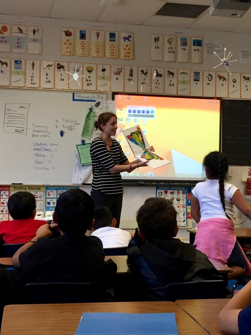Kat reading The Very Hungry Caterpillar to 2nd graders at Yokomi Elementary
