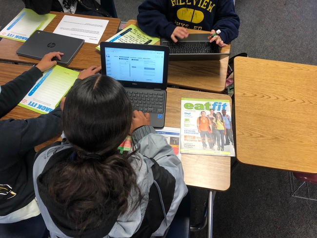 Hillview student exploring and comparing foods from a restaurant's online nutrition calculator for an EatFit activity about fast food and how to choose healthy menu items.
