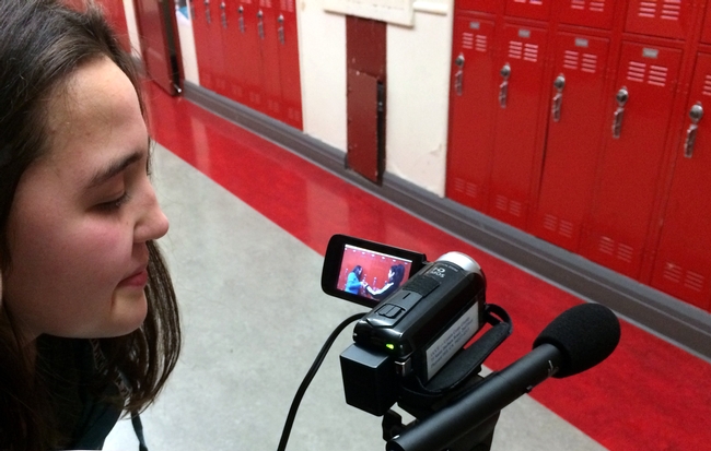 Teen reviewing video footage featuring the drinking water promotion message of the week