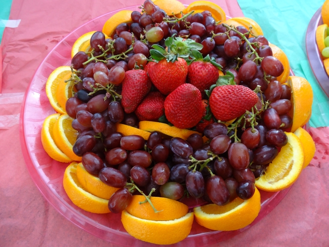 Plate of cut fruit and grapes