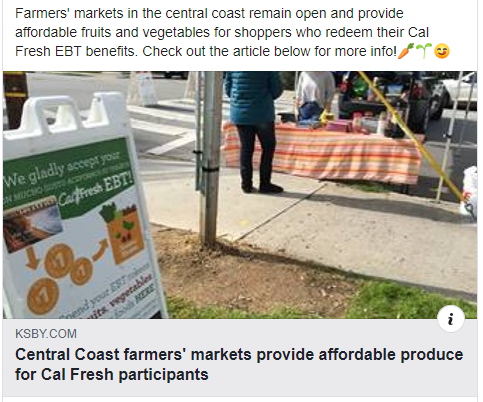 a sign posted at a farmers market that says We Gladly Accept EBT/CalFresh