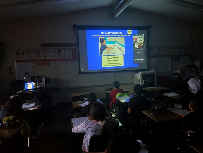 Photo of slideshow in classroom with students