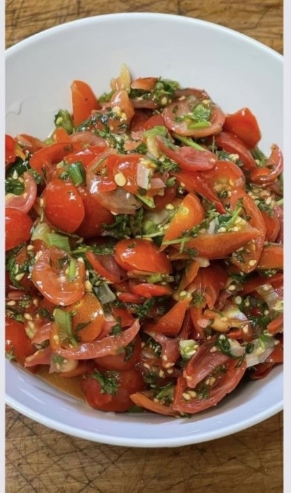 sliced cherry tomatoes in a pasta salad