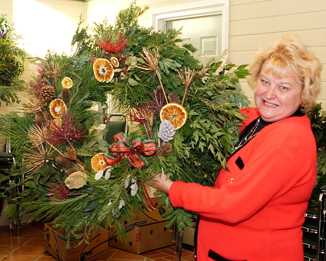 A wreath maker with her finished product.