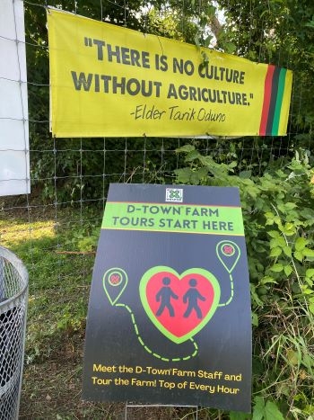 Colorful signs welcome visitors to lush urban farm