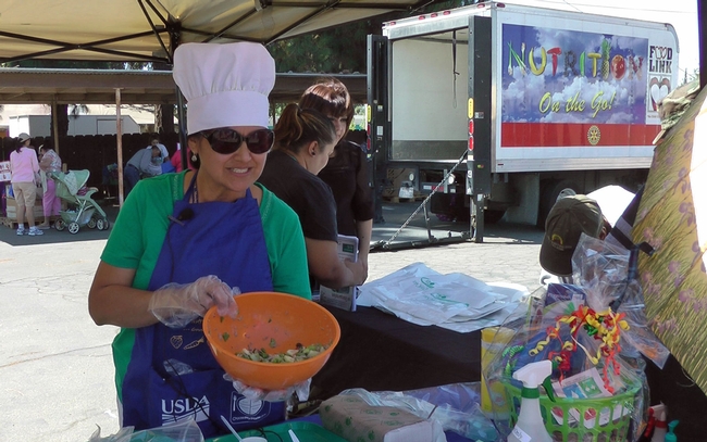 UCCE nutrition educator Grilda Gomez provides nutrition education at FoodLink of Tulare County fresh produce giveaway in Farmersville.