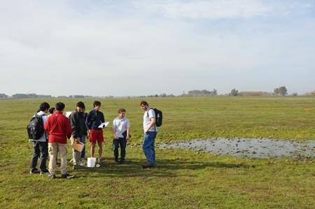 Students gather near a vernal pool near a nature preserve on the UC Merced campus.