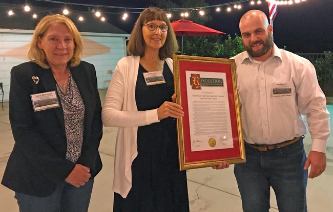 In recognition of UCCE Sutter-Yuba's centennial, Janine Hasey, center, was presented a Senate/Assembly Resolution by Laura Nicholson, senior district representative for state Senator Jim Nielsen, and Joe Brennan, who represented Assemblymember James Gallagher.