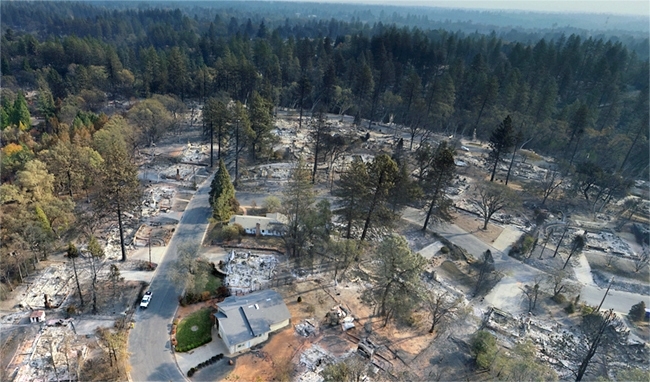 Drone footage of the Camp Fire aftermath shows homes destroyed while green trees are unscathed.