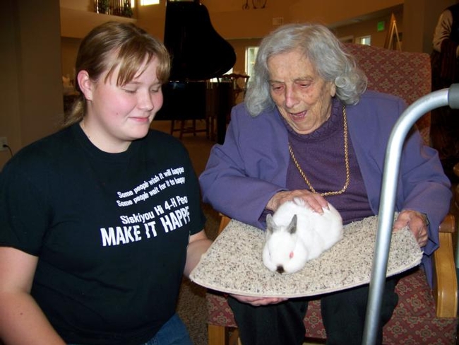In one Siskiyou County 4-H activity, members visited residents of an assisted living facility with dogs and other animals.