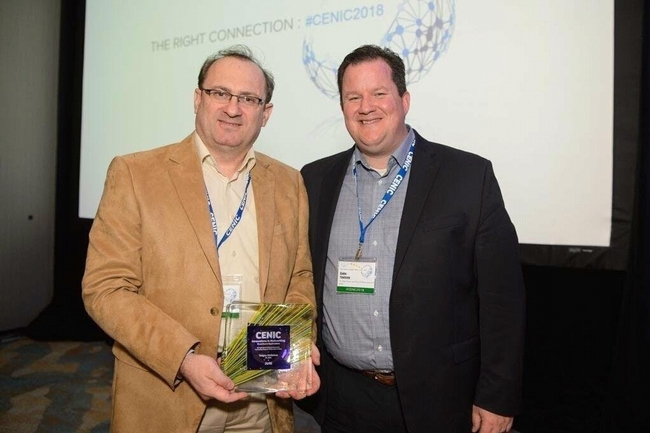 Tolgay Kizilelma, left, and Gabe Youtsey accept CENIC 2018 Innovations in Networking Award for Broadband Applications.