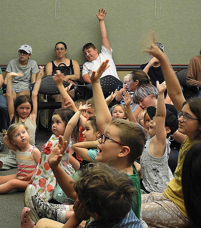 How many of you like insects? Hands shoot up at the Bohart Museum presentation at the Vacaville Public Library. (Photo by Kathy Keatley Garvey)