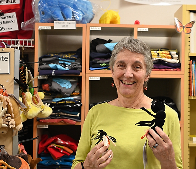 UC Davis distinguished professor Lynn Kimsey, director of the Bohart Museum of Entomology, holds some of the stocking stuffers available in the Bohart git shop. (Photo by Kathy Keatley Garvey)