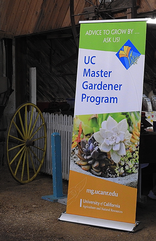 A sign pointing the way to the UC Master Gardeners' booth at the Dixon May Fair. (Photo by Kathy Keatley Garvey)