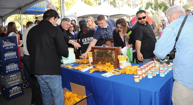 Crowd filters into the California Ag Day celebration. This is the California State Beekeepers' Association booth. (Photo y Kathy Keatley Garvey)