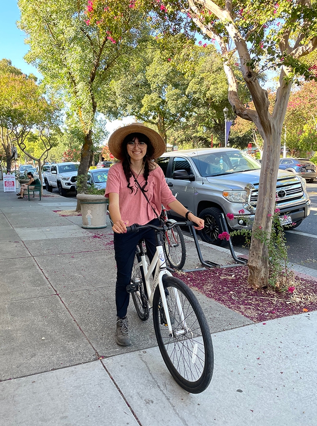 Samantha Murray, shown here on her bicycle, is a UC Davis senior majoring in music. She specializes in the harp.