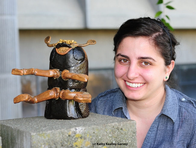 Kristina Tatiossian and the ceramic mosaic of a walnut twig beetle. (Photo by Kathy Keatley Garvey)