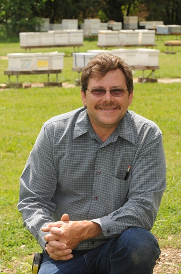 Brian Fishback in front of the apiary at the Harry H. Laidlaw Research Facility. (Photo by Kathy Keatley Garvey)
