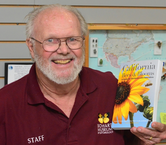 Native pollinator specialist Robbin Thorp with a copy of the book. (Photo by Kathy Keatley Garvey)