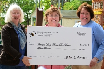 Debra Jamison (center), state regent of the California State Society of the Daughters of the American Revolution and Karen Montgomery (far right), state regent project chair, present the check to haven manager Chris Casey. (Photo by Kathy Keatley Garvey)