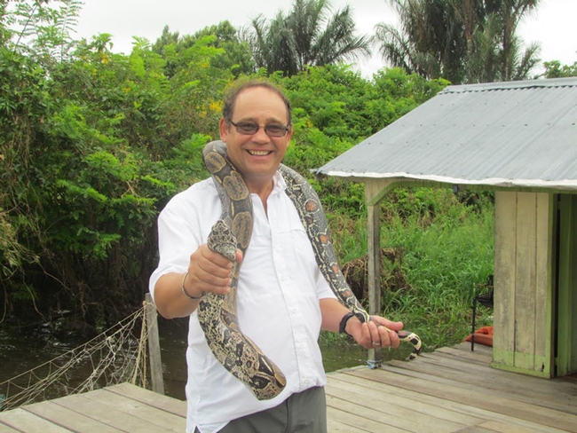 Medical entomologist Anthony Cornel with a snake in Brazil.