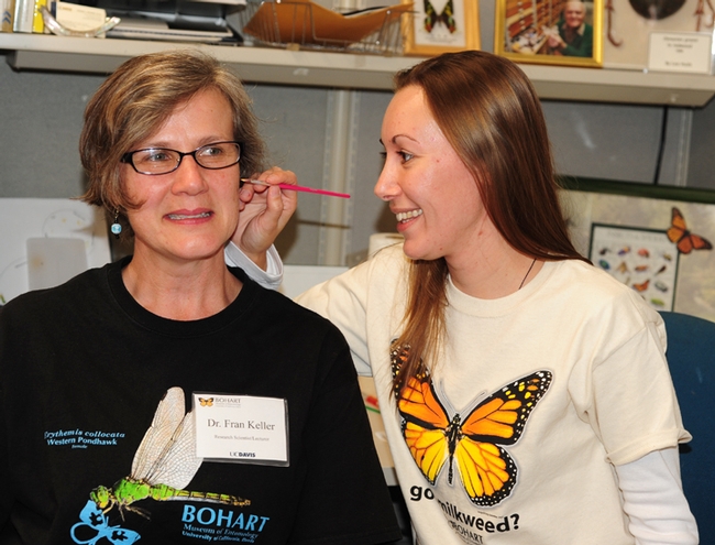 Entomologist Fran Keller, who received her doctorate from UC Davis, smiles as student Jessica Gillung asks her which insect she wants. (Photo by Kathy Keatley Garvey)