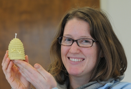 BEEKEEPER Elizabeth Frost shows a miniature beehive candle she made from beeswax and a little paraffin - 2903