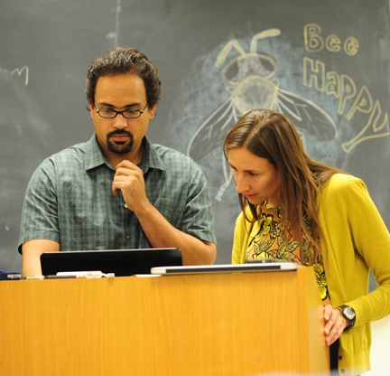 Honey bee scientist Brian Johnson, UC Davis assistant professor of entomology, confers with Amy Toth prior to her seminar at UC Davis. Note the bee drawing in the background. (Photo by Kathy Keatley Garvey)