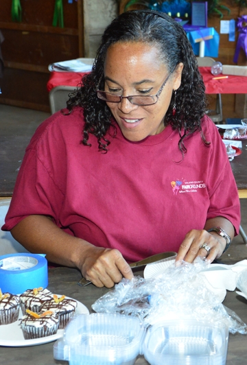 Iris Mayhew of Vallejo works on exhibits in McCormack Hall, Solano County Fair. One of her passions is art. (Photo by Kathy Keatley Garvey)