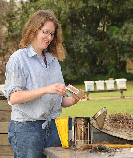 Liz Frost lights the smoker at the Harry H. Laidlaw Jr. Honey Bee Research Faciity. (Photo by Kathy Keatley Garvey)